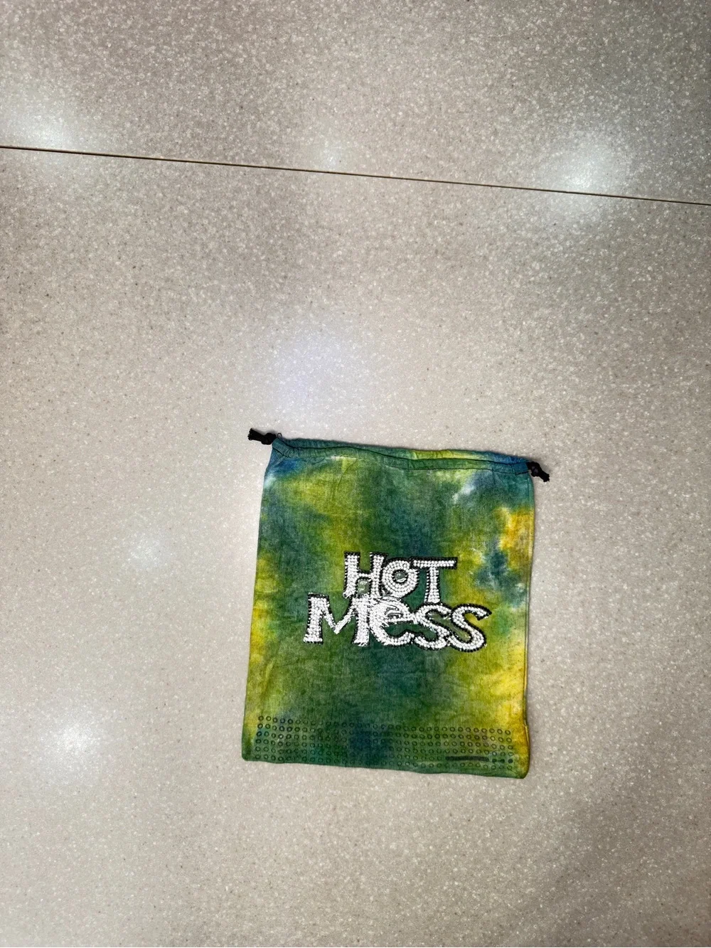 Bag - Hot Mess on one side and a glow-in-the-dark dinosaur.